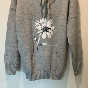 Gray knit tunic length funnel neck sweater with flower motif and kangaroo pocket